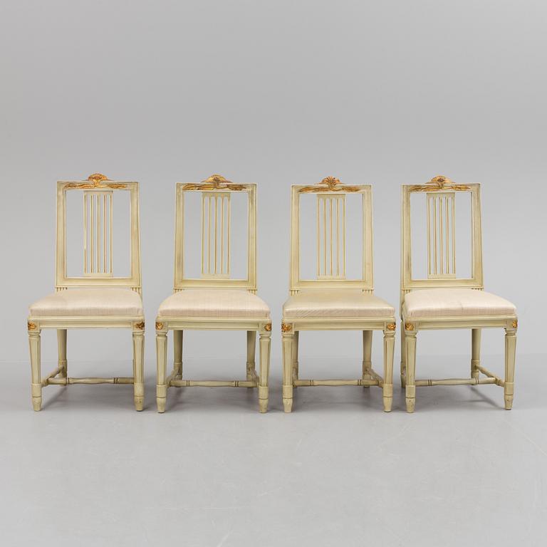 A lot of four mid 20th century Swedish Gustavian style chairs and one dinner table from around year 1900.