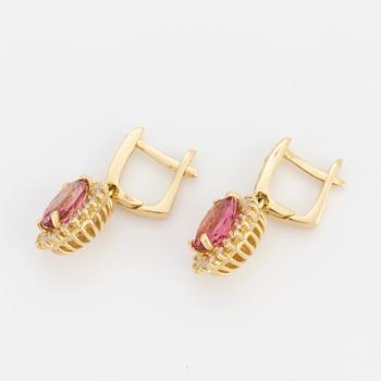 A pair of earrings set with pink tourmalines and diamonds.