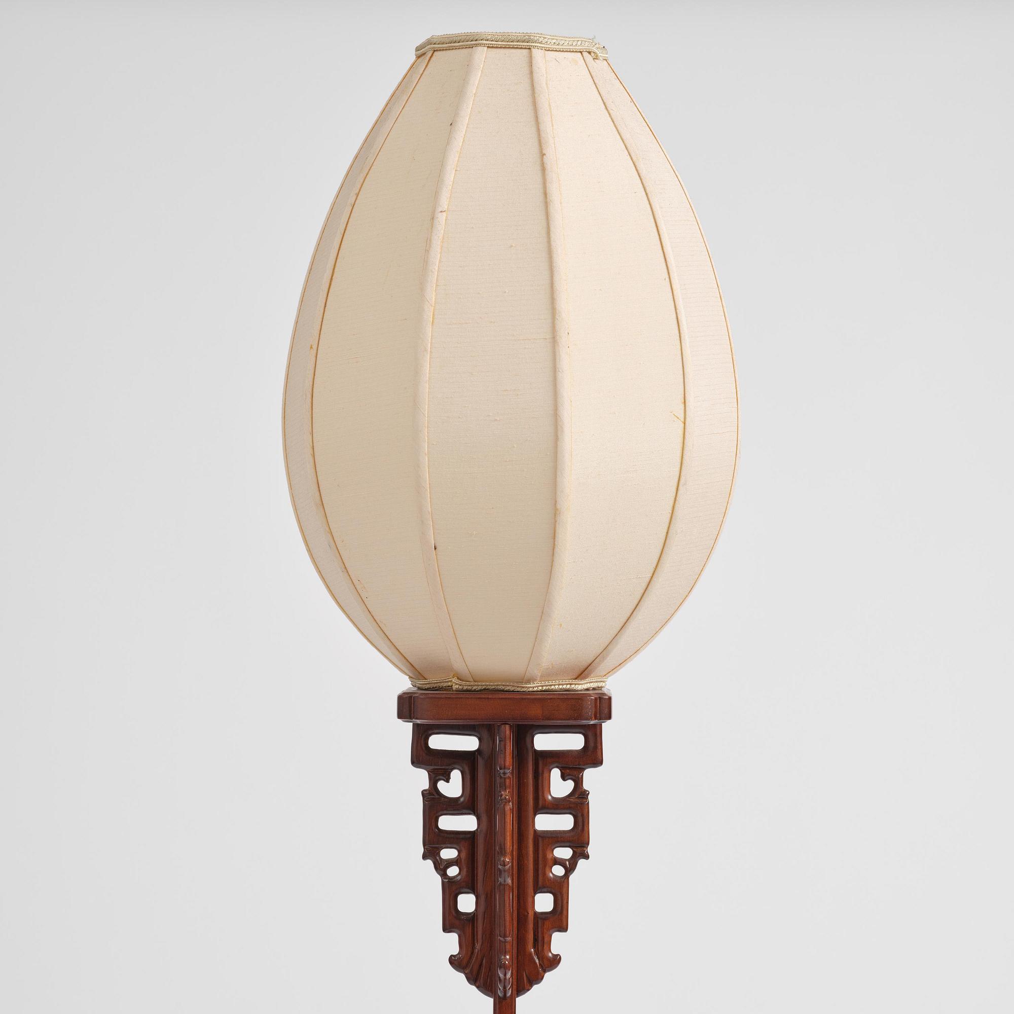 A Chinese wooden floor lamp, later part of the 20th century.