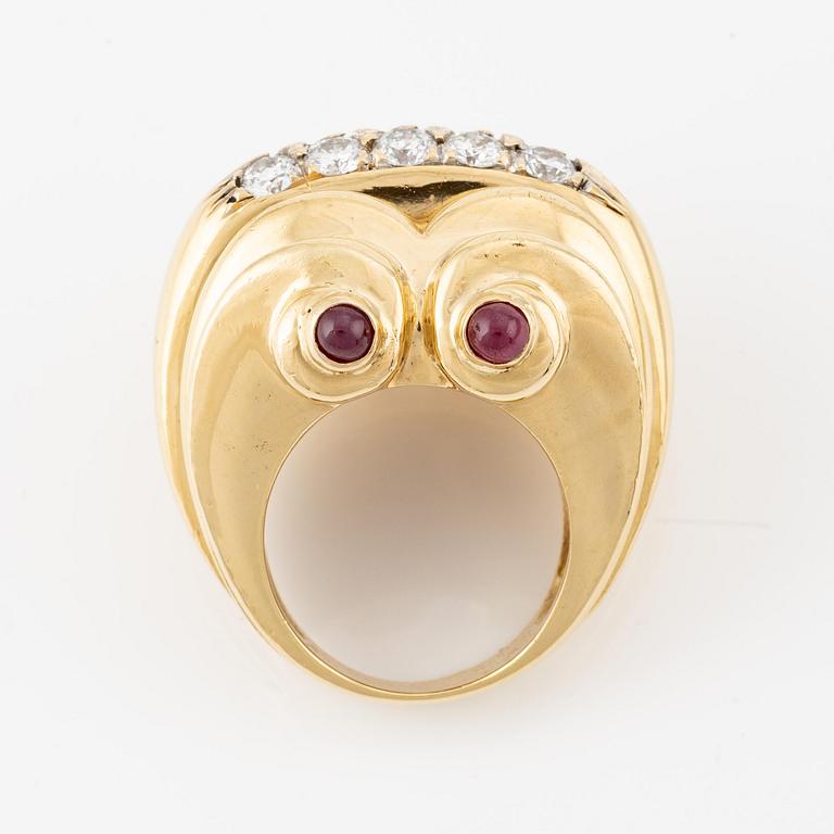 An 18K gold ring set with round brilliant-cut diamonds and cabochon-cut rubies.