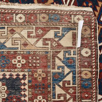 A RUG. A semi-antique Kuba/Shirvan. 165,5 x 129,5 cm (as well as one end with one cm flat weave).