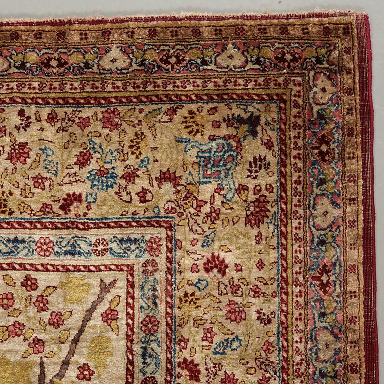 A CARPET, a semi-antique silk Tabriz figural, signed Haddad, 180,5 x 123,5 cm.