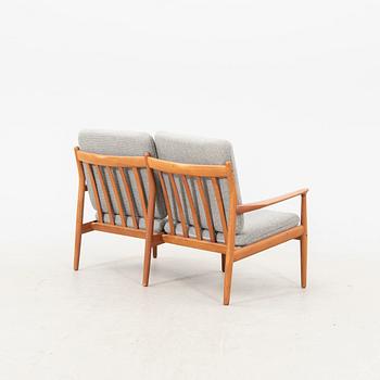 A Grete Jalk teak armchair and sofa from Glostrup Denmark, 1960s, marked.