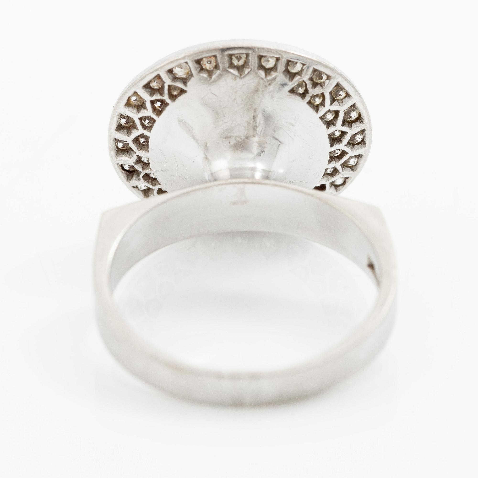 A ring 18K white gold set with an opal and eight-cut diamonds. CF Carlman, Stockholm 1973.