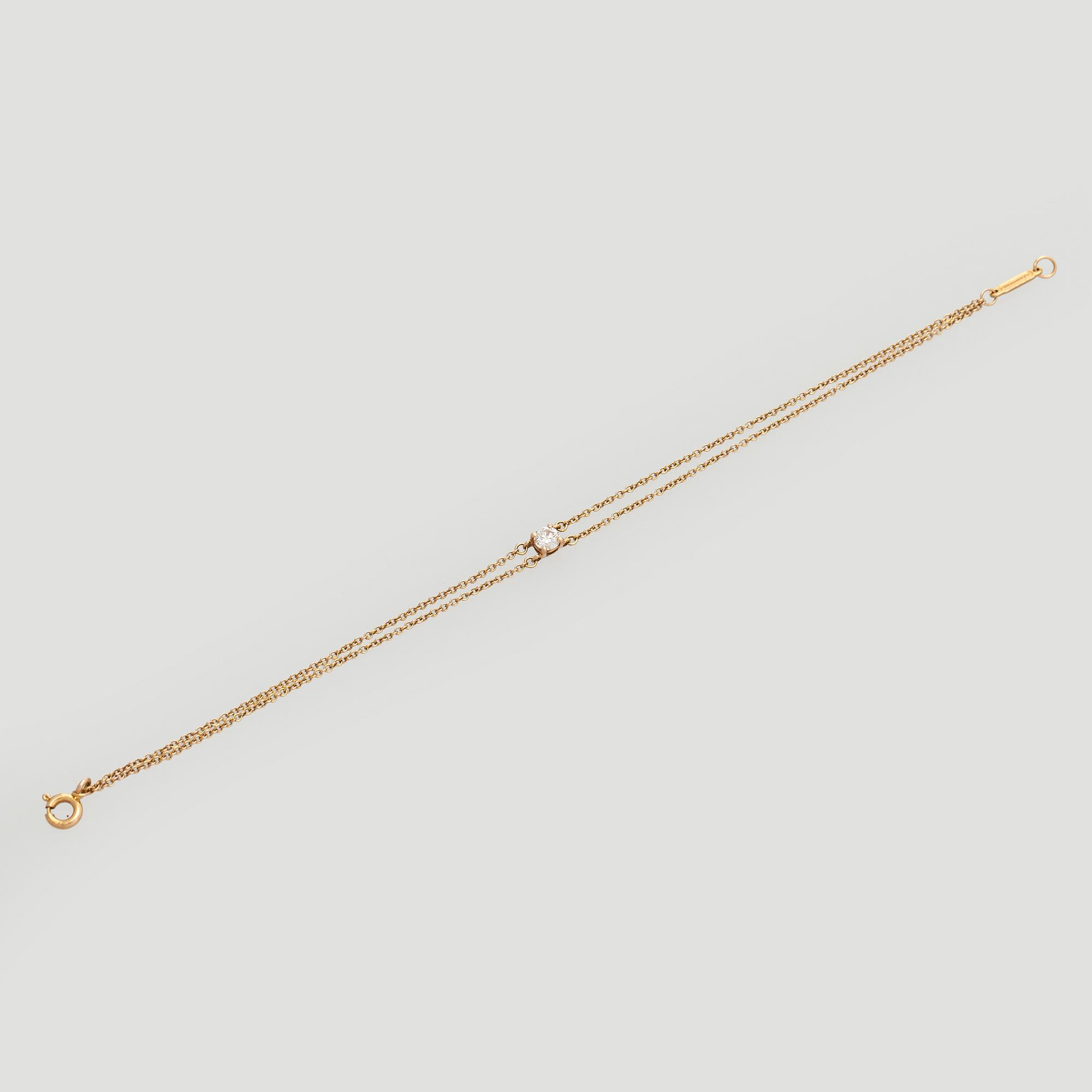 Tiffany & Co, armband, 18K guld med en briljantslipad diamant.