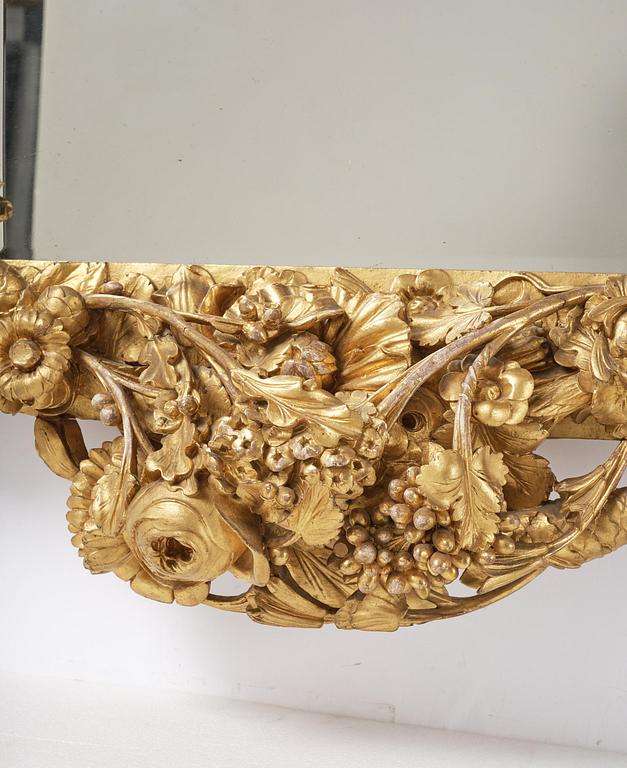 A presumably Dutch Louis XIV carved giltwood frame with mirror glass, in the style of Jean Le Pautre, late 17th century.