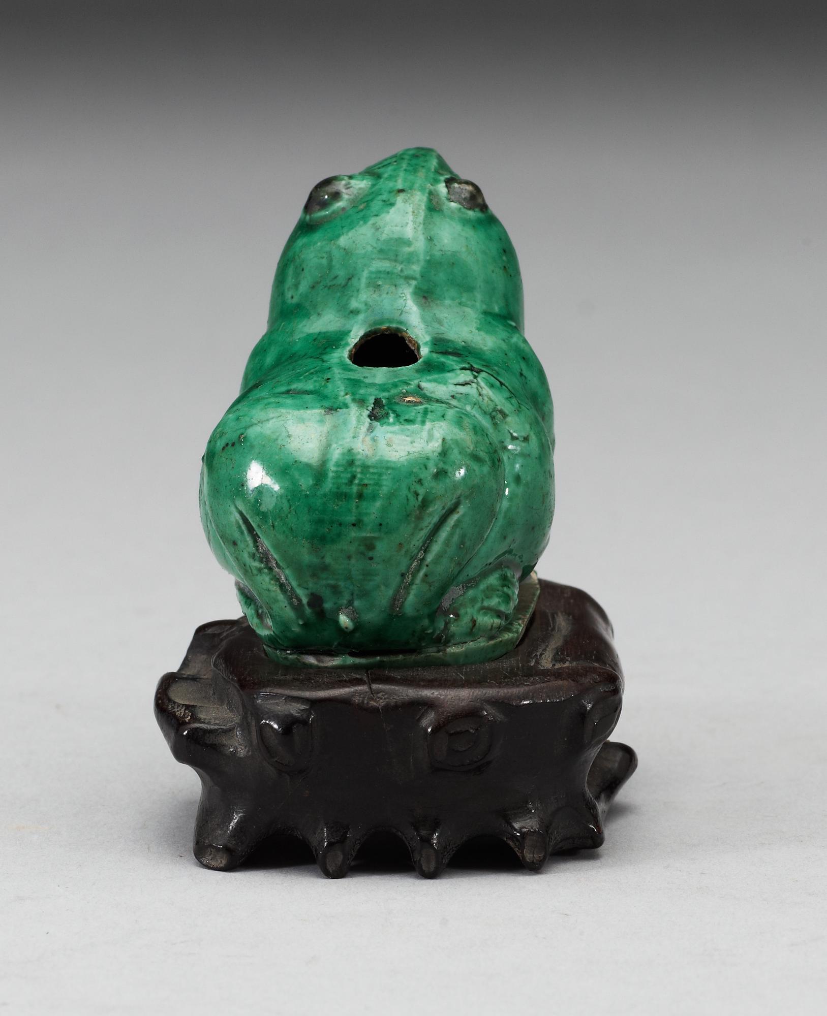 A green glazed biscuit water dropper, in the shape of a frog, Qing dynasty, Kangxi (1662-1722).