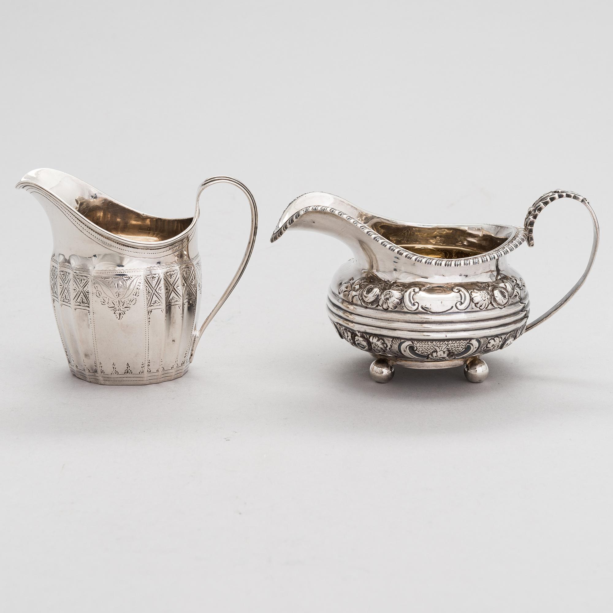 Two sterling silver milk jugs, London 1794 och 1828.