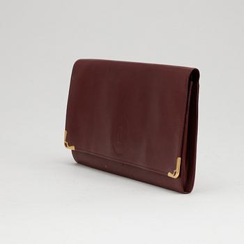 CARTIER, a red leather clutch or travel wallet.