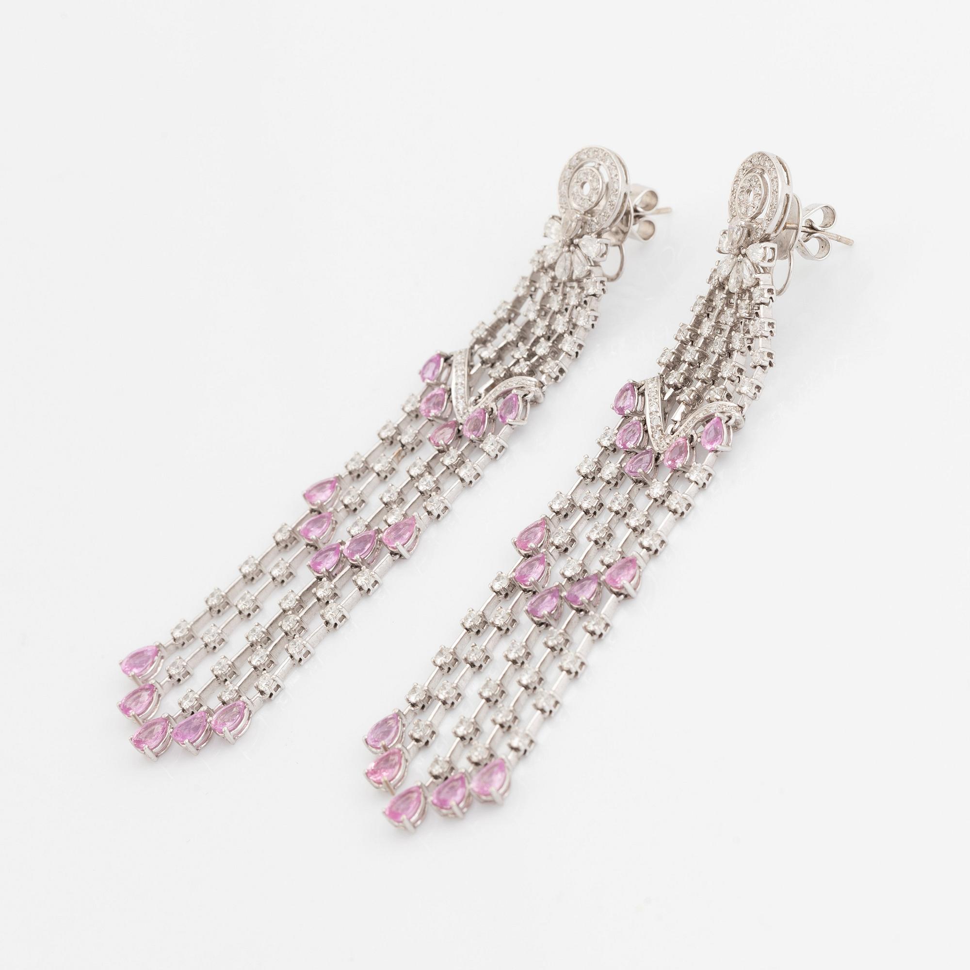 A pair of 18K white gold earrings set with faceted pink sapphires and round brilliant-cut diamonds.
