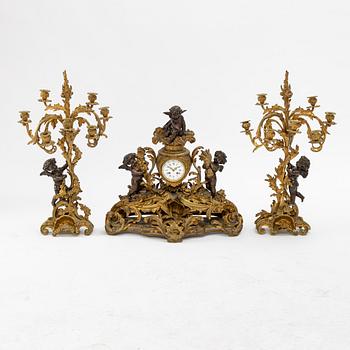 A grand mantle piece set with a clock and a pair of candelabras, Louis XV-style, second half of the 19th century.