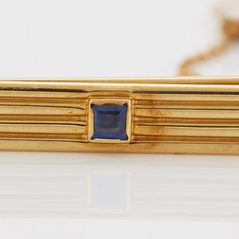 A 1960/70's tie-clip decorated with a carré-cut sapphire by Dupont, Paris.