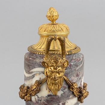 A pair of marble urns with bronze mountings from around year 1900.