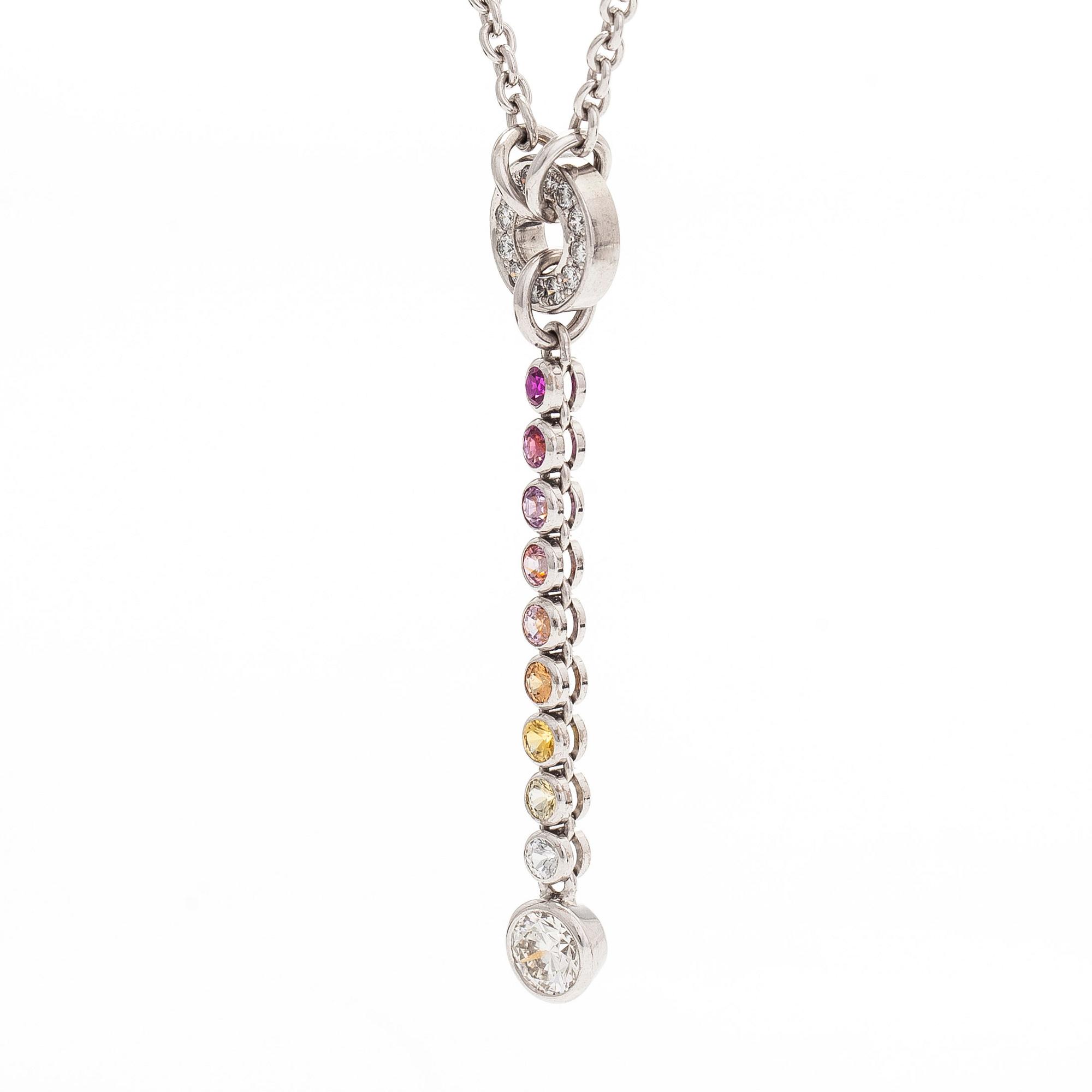 An 18K white gold necklace, set with brilliant-cut diamonds, a ruby, and sapphires. Kultaseppä Kulmala, Helsinki.