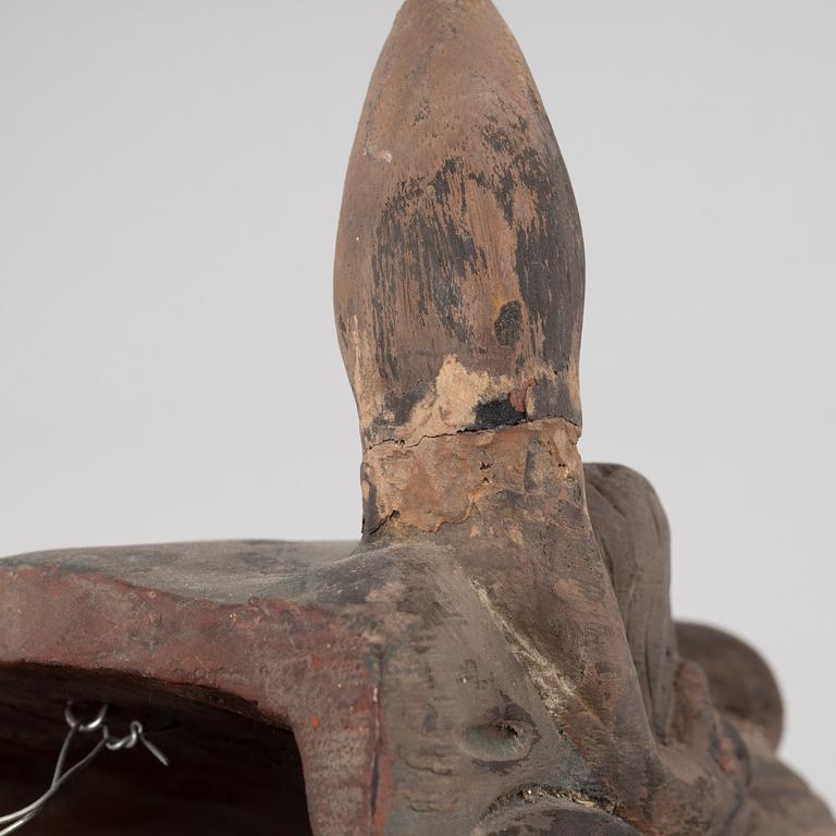 Four Tibetan/South East Asian wooden decorations, 20th century.