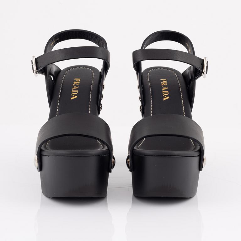 Prada, a pair of wood and leather sandals, size 37.