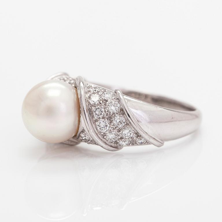 An 18K white gold ring, with a cultured pearl and diamonds totalling approximately 0.70 ct.