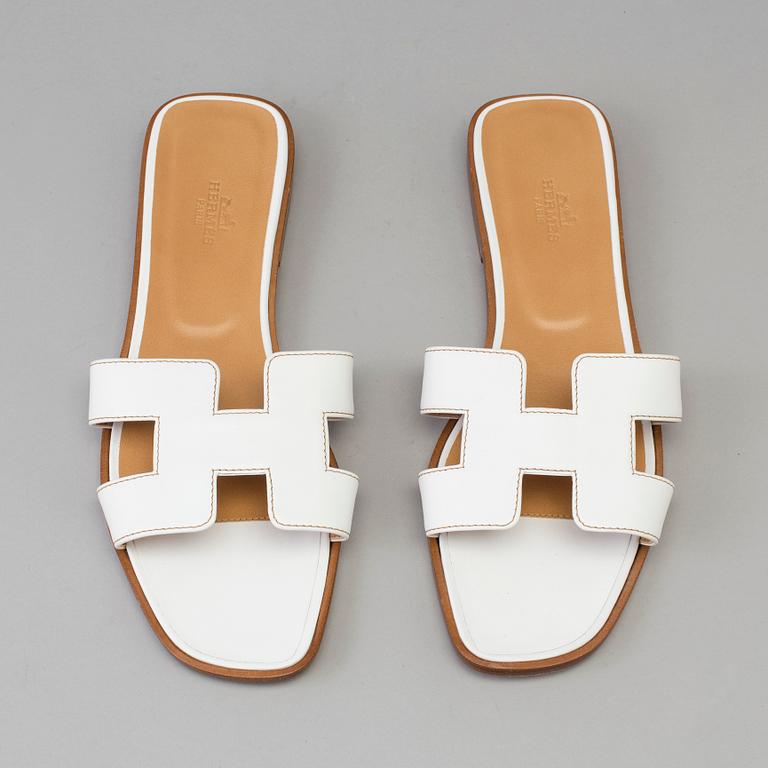 A pair of white leather shoes by Hermès.