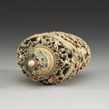 A deeply carved ivory snuff bottle with cover, China, early 20th Century.