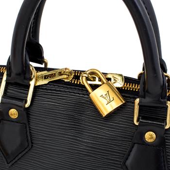 A black epi "Alma" handbag and keyholder by Louis Vuitton.