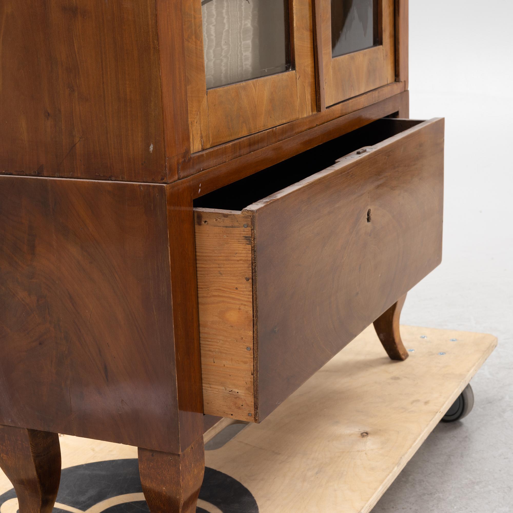 A mahogany veneered book cabinet. 19th Century.