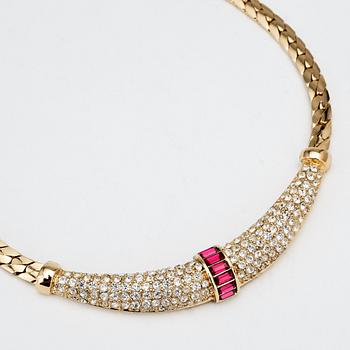 CHRISTIAN DIOR, a gold colored necklace and a pair of earclips.