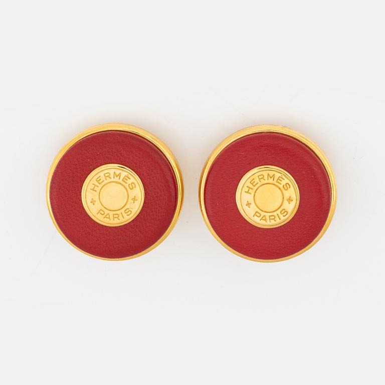 Hermès, a pair of gold tone metal and leather clip-on earrings.