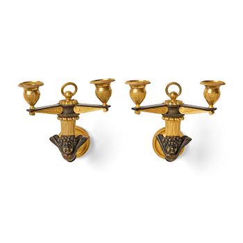 157. A pair of Empire patinated and ormolu two-branch appliques attr. to C. Galle (bronzier in Paris 1786-1815).
