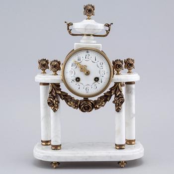 A French mantlepiece clock and a pair of candelabras, first half of the 20th century.