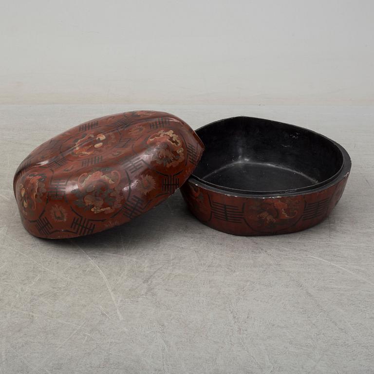 A massive Japanese wooden and lacquered box with cover, in the shape of a peach, early 20th century.