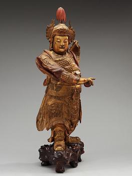 A lacquered and gilt wooden figure of a warrior, Qing dynasty, ca 1800.