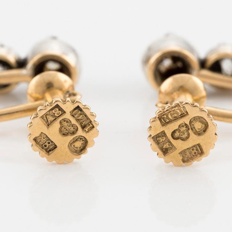 A pair of silver and gold earrings with drop-shaped pearls and old- and rose-cut diamonds.