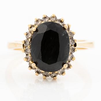 Ring, 18K gold with dark sapphire and brilliant-cut diamonds.