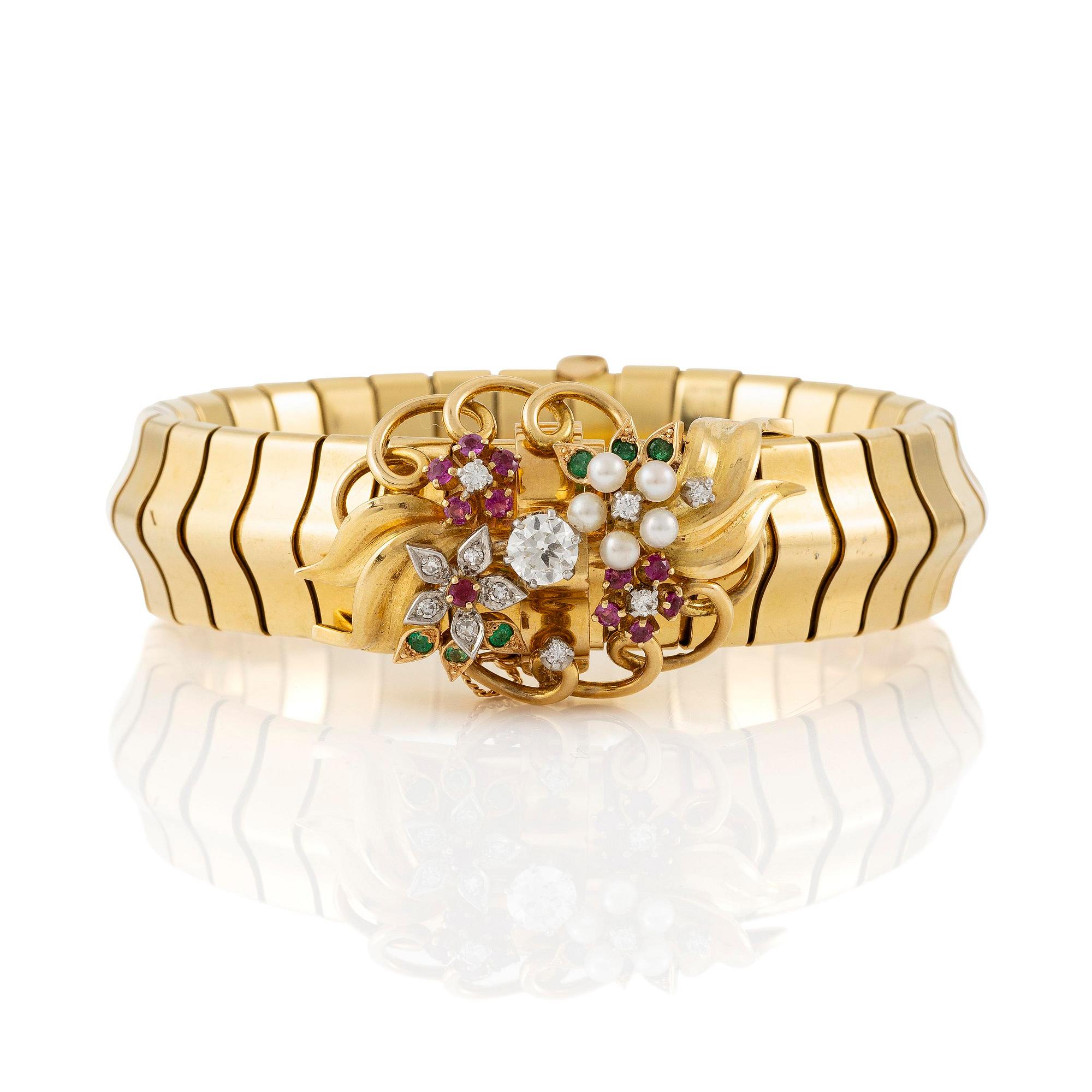A Strömdahls bracelet/pendant combination in 18K gold with rubies, emeralds, pearls and diamonds.