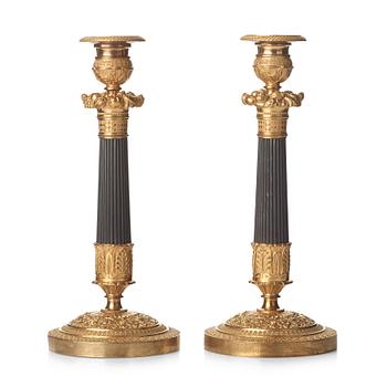 73. A pair of French Empire candlesticks, early 19th century.