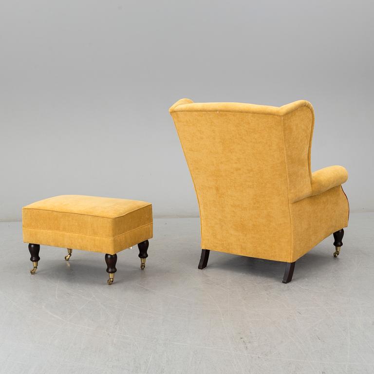 A 'York Wing Chair' easy chair with foot stool from Parker Knoll, 21st Century.