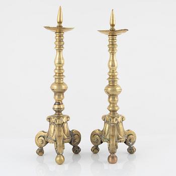 A pair of brass candle sticks, around 1700.