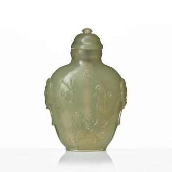 A Chinese carved nephrite snuff bottle with cover.