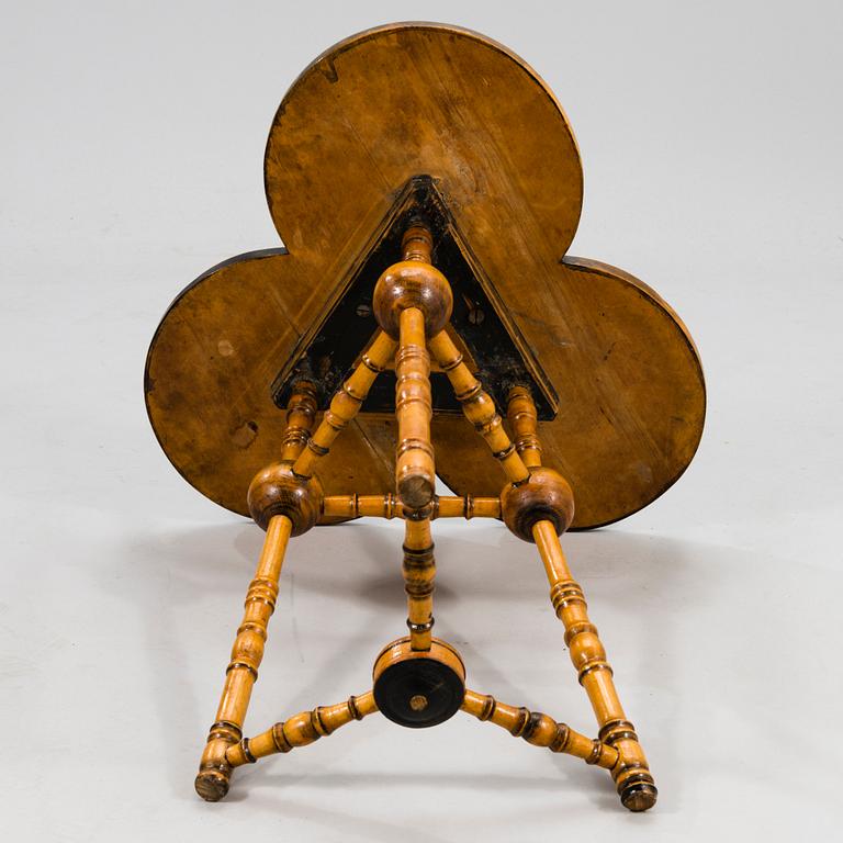 A wooden table from around 1900, cut decor.