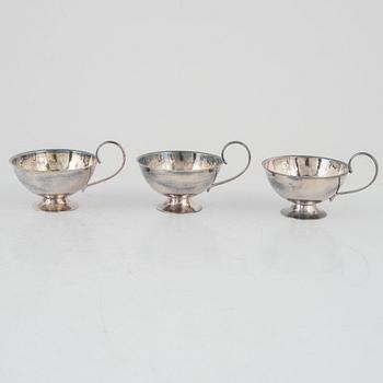 nine silver punsch mugs, Fritz Olsson AB and Ceson, Sweden, 1961, also two silver cups and two silver boxes.