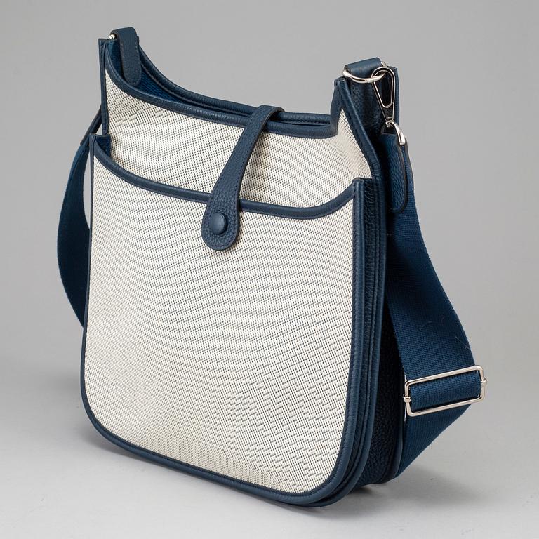 HERMÈS, a canvas and blue leather crossbody bag, "Evelyn".