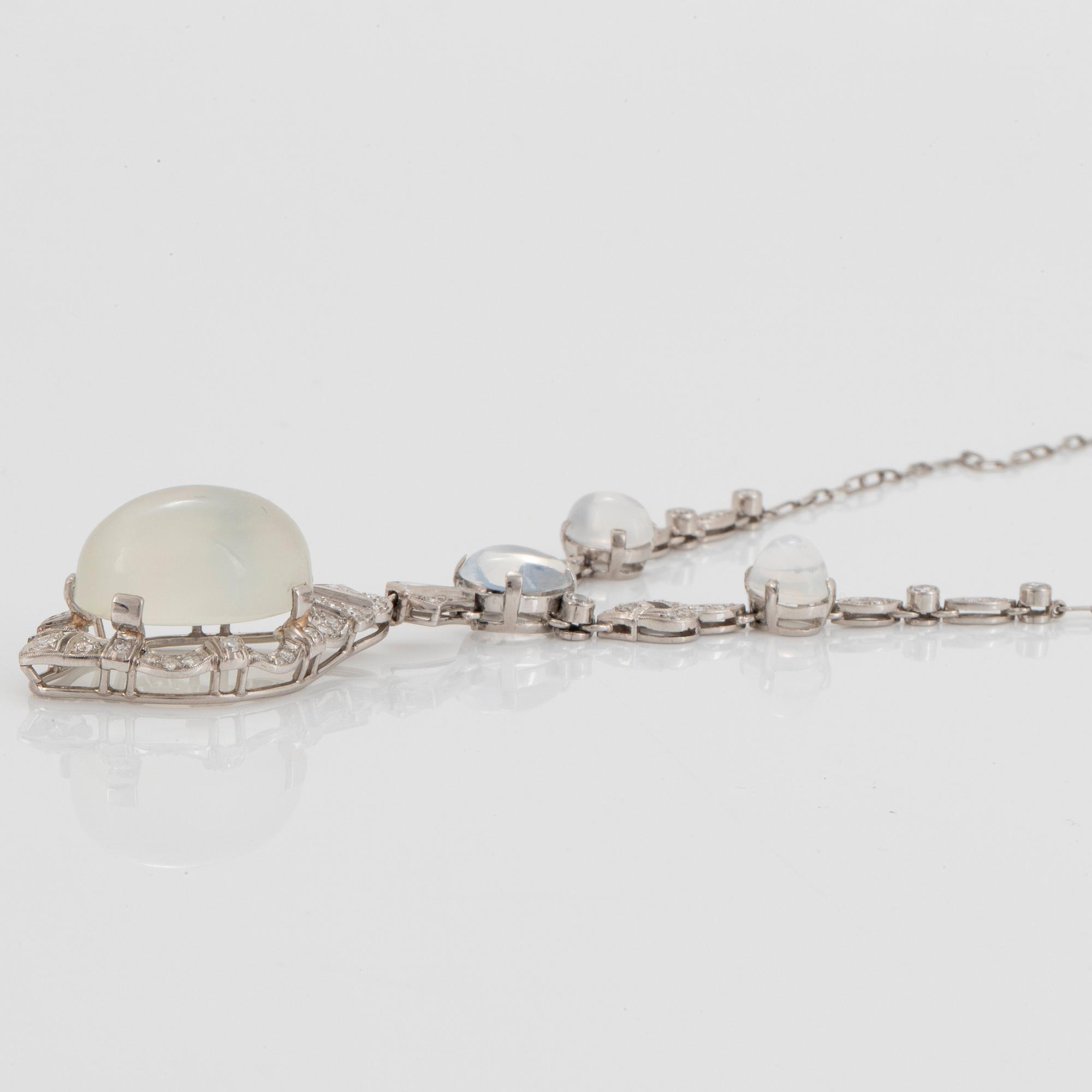 A platinum necklace set with moonstones and old- and eight-cut diamonds.
