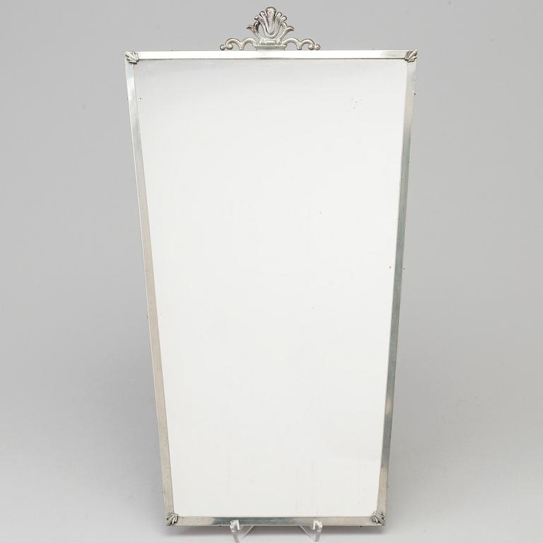 A Swedish pewter mirror dated 1935.