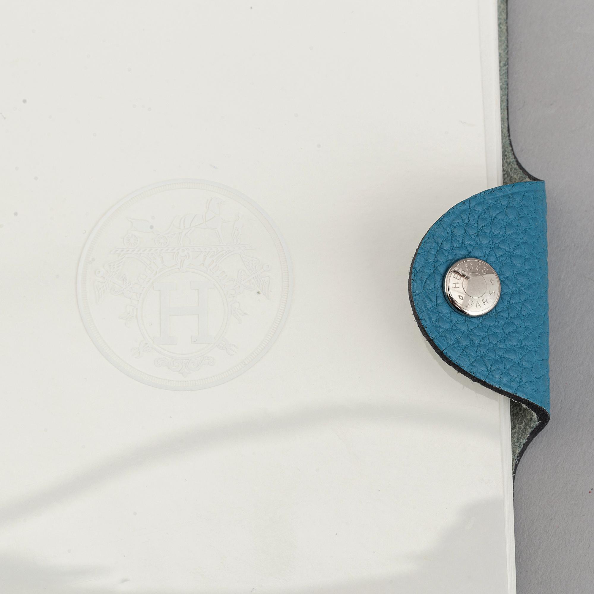 Hermès, a blue leather notebook with two scripple pads.