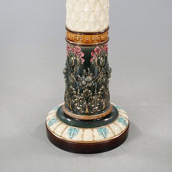 A Rörstrand pedestal with pot in majolica, made around year 1900.