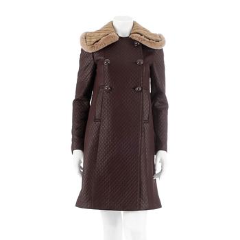 422. PRADA, a brown quilted overcoat, size 38.