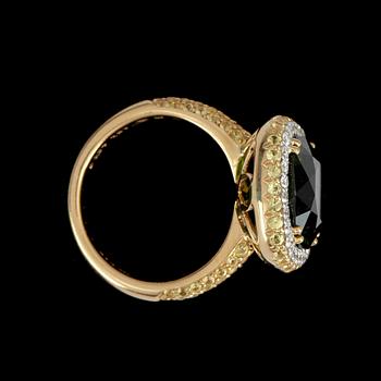 A peridot, circa 17.76 cts, and diamond, circa 1.58 cts, ring.