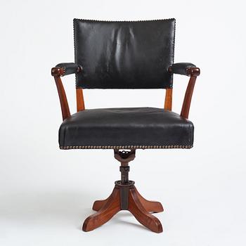 Josef Frank, a mahogany and black leather swivel chair, modified version of model 695, Svenskt Tenn, ca 1956-1957.