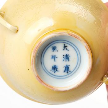 An imperial yellow glazed two handled wine cup, Qing dynasty, Kangxi mark and of the period (1662-1722).