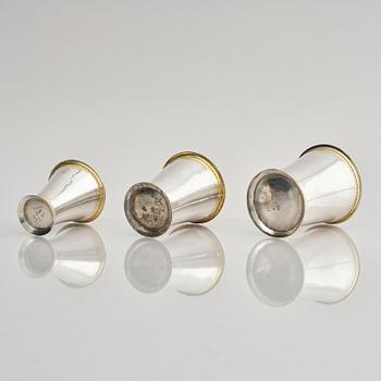 Three Swedish 18th century parcel-gilt silver beakers and a case of birch, different maker's.